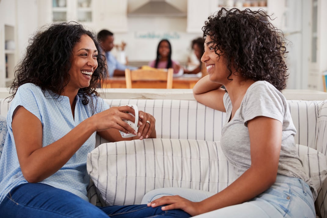 Mother Talking with Teenage Daughter on Sofa